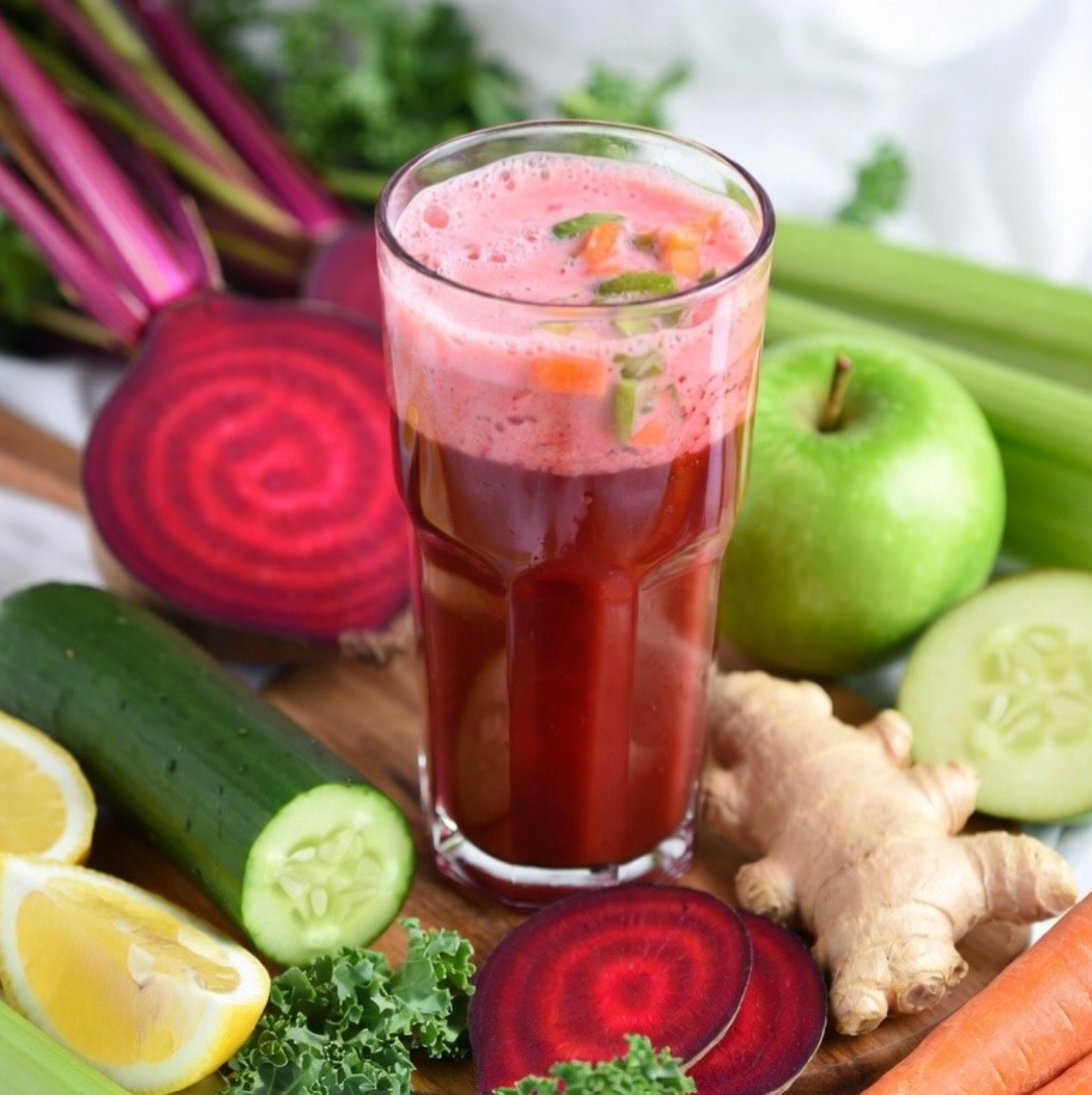 Fresh cold-pressed juice with beets, ginger, celery and greens